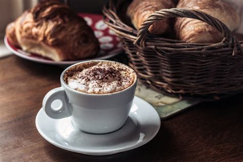 Frothy Coffee And Croissant Royalty Free Stock Photo