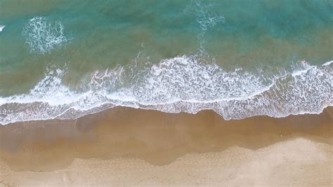Aerial Footage Of Tropical Sandy Beach With Waves Breaking On Shore
