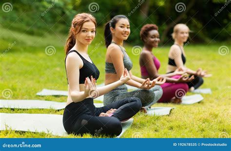 Group Of Diverse Young Girls Practicing Meditation Sitting On Yoga