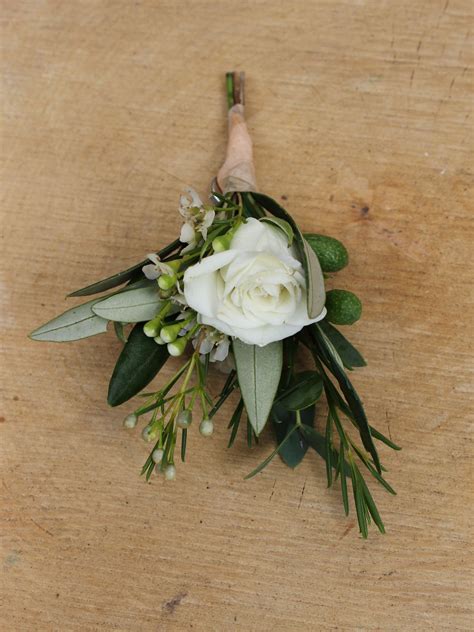 Grooms Buttonhole A Mix Of Foliages With A Touch Of Flower With An Ivory Spray Rose Bud