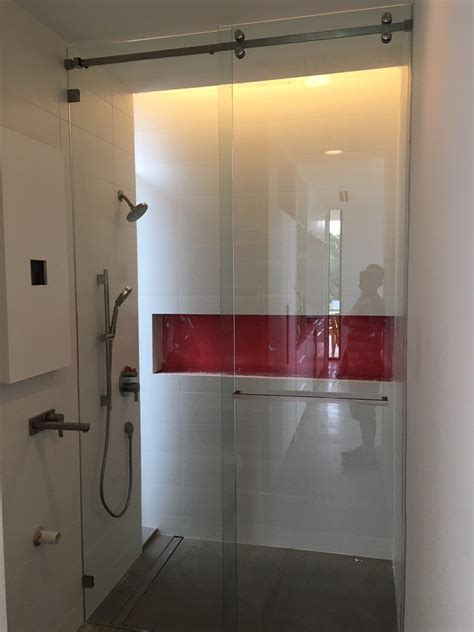 serenity shower with a sliding door and stationary panel square towel bar through the glass