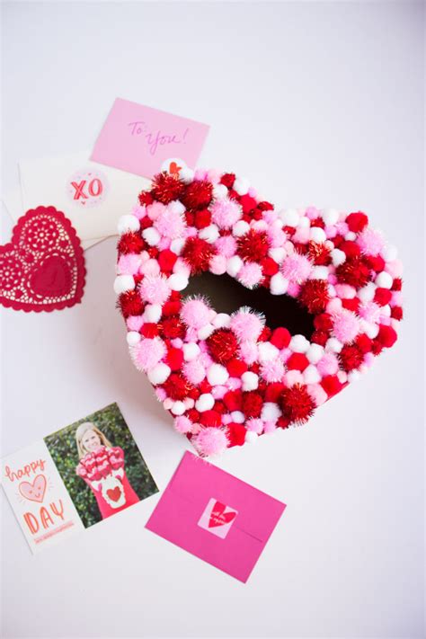 Click here for 20 valentine card boxes with tutorials. DIY Pom-Pom Heart Valentines Box - Design Improvised