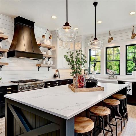 Today's black and white modern farmhouse kitchen pairs with rich wood for a warm and inviting look. This sophisticated and chic modern farmhouse open concept ...