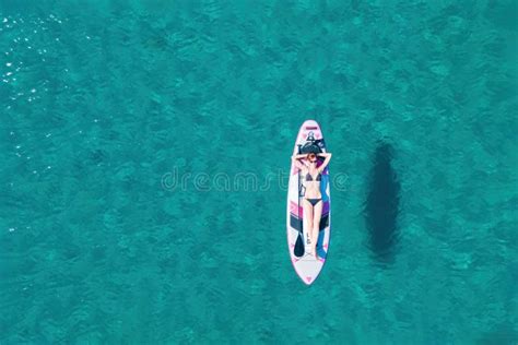Woman Paddle On Sup Board Doing Water Sport During Summer Holidays