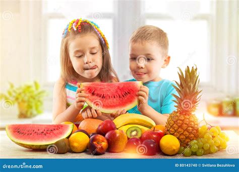 Kids Eating Watermelon In The Garden Stock Image