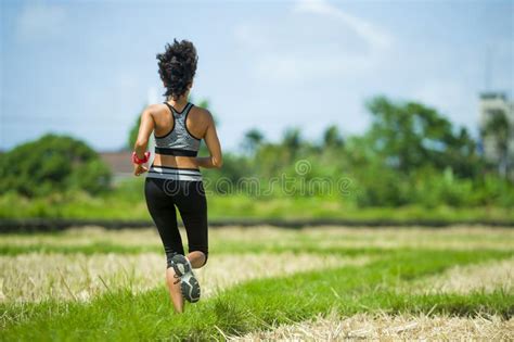 Back View Of Young Runner Woman With Attractive And Fit Body In Running