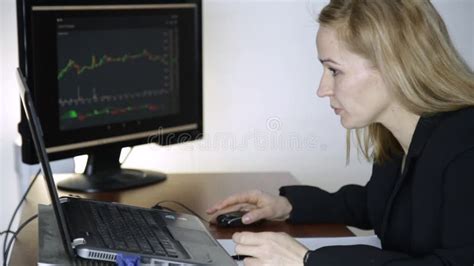 Female Trader Working On Laptop In Office Work On A Crypto Stock