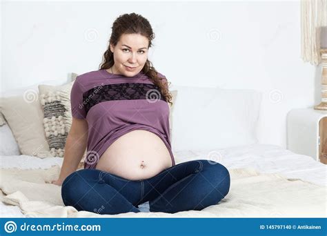Portrait Of Joyful And Smiling Pregnant Woman With Naked