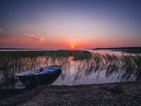 Sunset On The Lake Fishing Boat On The Shore Stock Image Image Of