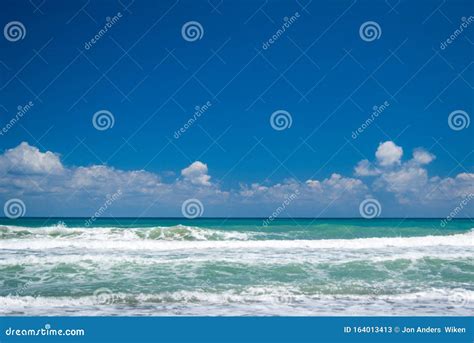 Beautiful Landscapeseascape Of Green Ocean And Blue Cloudy Sky In