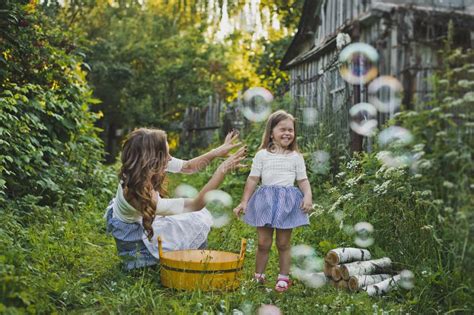 mom and daughter blowing bubbles outdoors 4711 stock image image of background bubbles