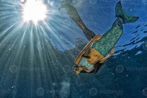 Two Mermaid Swimming Underwater In The Deep Blue Sea 20347083 Stock