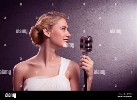Attractive Female Singer With Microphone Stock Photo Alamy