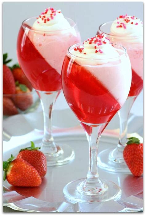 Three Glasses Filled With Liquid And Topped With Strawberries