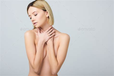 Tender Naked Woman Covering Breast And Posing Isolated On Grey Stock
