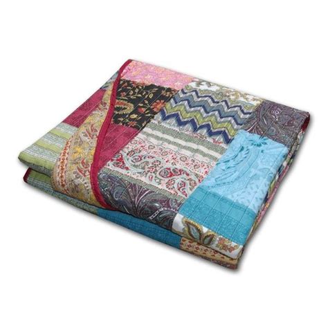 A Multicolored Patchwork Blanket Is Folded On Top Of Each Other With