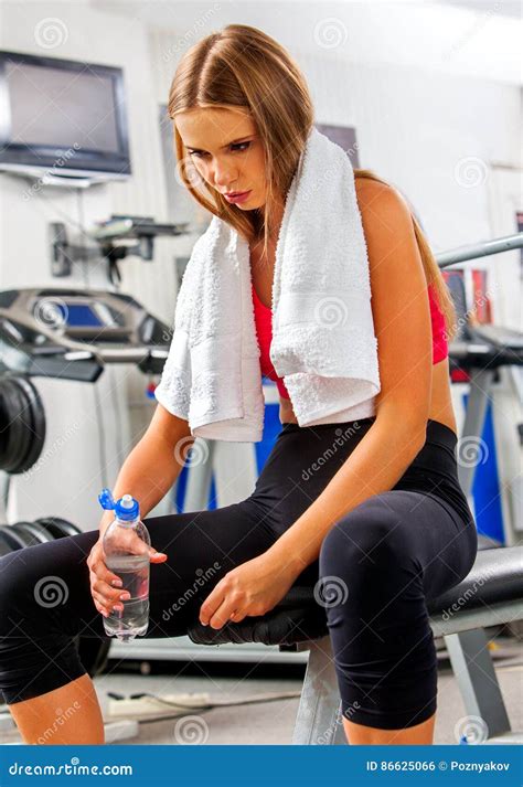 Woman In Gym Workout Fitness Equipment Girl Drink Bottle Water Stock