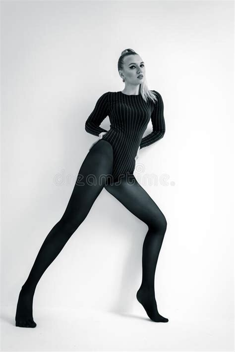 Fashion Model In Black Tights On The White Background Acrobatic