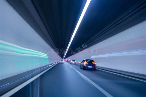 Car Driving Through An Illuminated Tunnel Blurry Long Exposure Of