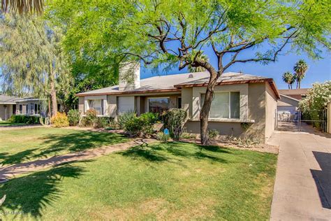 A House With Trees And Grass In The Front Yard