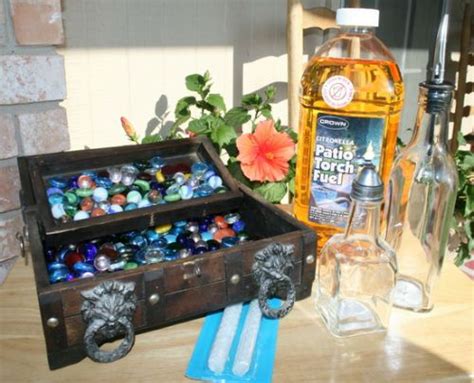 An Old Trunk With Marbles In It Sitting On A Table Next To Some Bottles