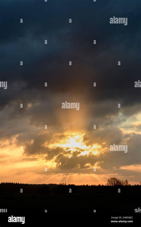 Sunrise With Sunrays Through Dark Clouds Stock Photo Alamy