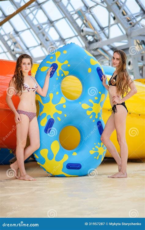 Smilng Women In Bikini Riding At The Water Slide In The Aqua Park Stock