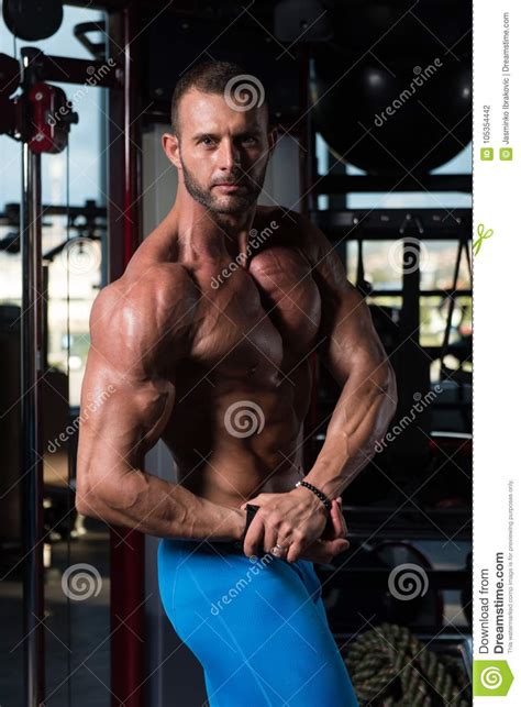 Handsome Muscular Man Flexing Muscles In Gym Stock Photo Image Of