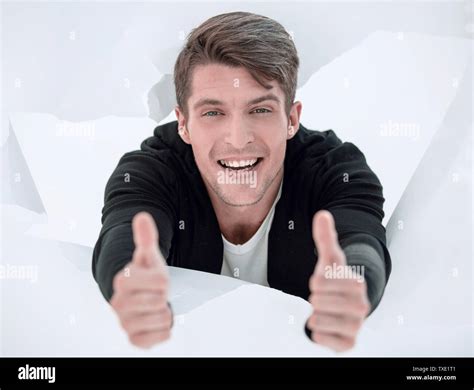 Man Breaking Through Paper Wall And Showing Thumbs Up Stock Photo Alamy