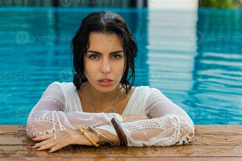 Beautiful Sensual Woman With Perfect Tan Skin In Wet Boho Outfit Posing In Swimming Pool