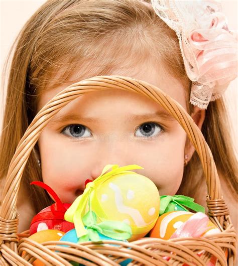 Little Girl With Basket Full Of Colorful Easter Eggs Stock Image