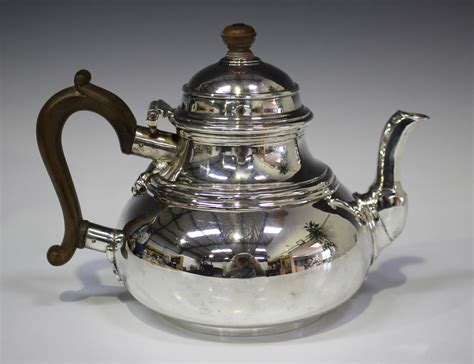 A George I Style Silver Teapot Of Low Bellied Circular Form With Hinged