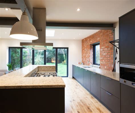Industrial Kitchen With Exposed Brick And Stainless Steel Features