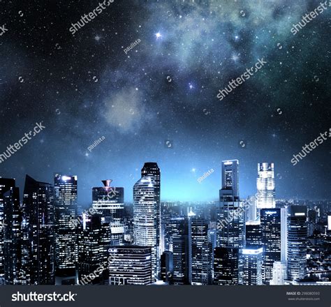 City Skyline At Night Under A Starry Sky Stock Photo