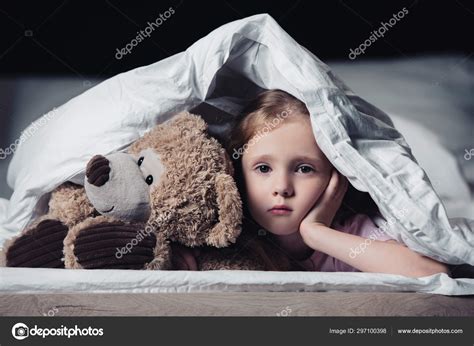 Frightened Kid Looking Camera While Lying Teddy Bear Blanket Isolated
