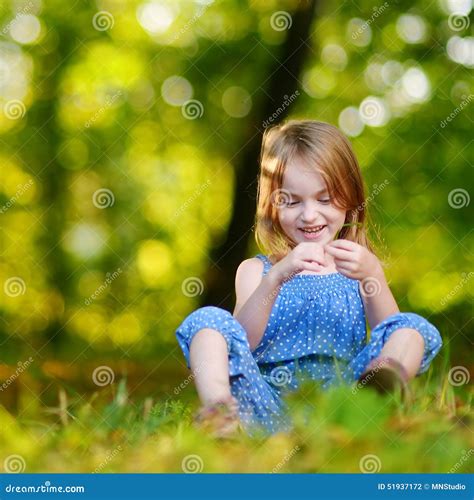 Cute Little Girl Sitting On The Grass On Summer Stock Photo Image Of
