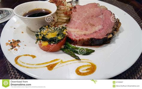 Prime rib, also known as standing rib roast, is a choice cut of beef. Prime rib dinner stock image. Image of potato, food ...