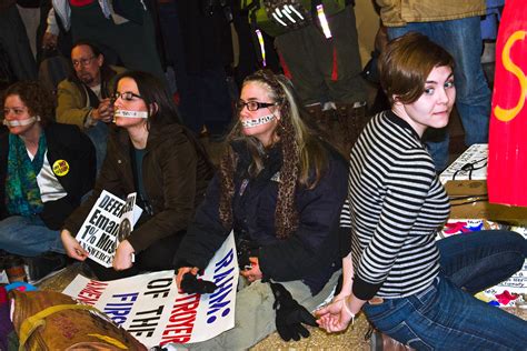 protestors feign being zip tied and silenced outside chica… flickr