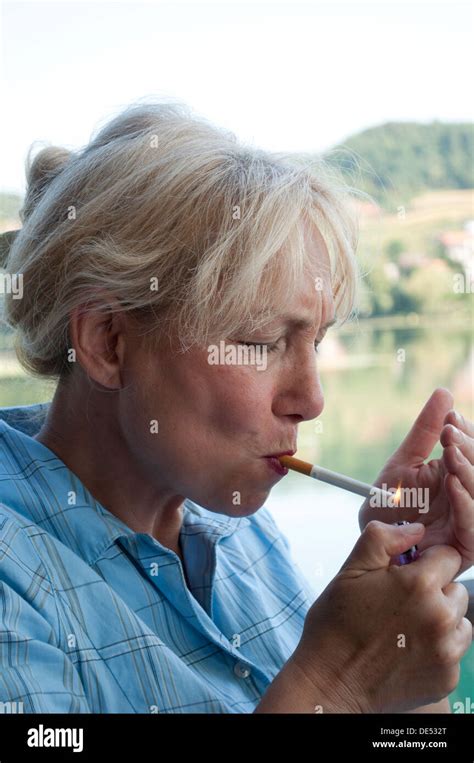 Middle Aged Woman Lighting Up A Cigarette Stock Photo 60348480 Alamy
