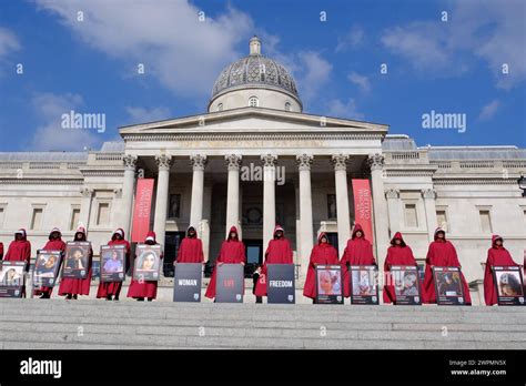 London, UK, 8th March, 2024. British-Iranians dressed in handmaids tale