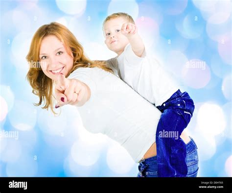 Mother And Son Point Out With Blue Lights In The Background Stock Photo