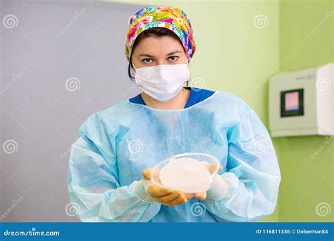 Surgeon Preparing Breast Silicone Implant For The Operation Stock Photo