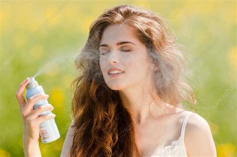 Woman Spraying Water On Her Face Stock Image C032 9578 Science Photo Library
