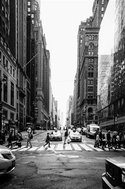 Grayscale Photo Of People Crossing The Road New York City City