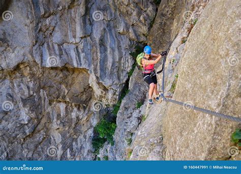 Female Tourist Traversing A Via Ferrata Section In Turda Gorge Cheile