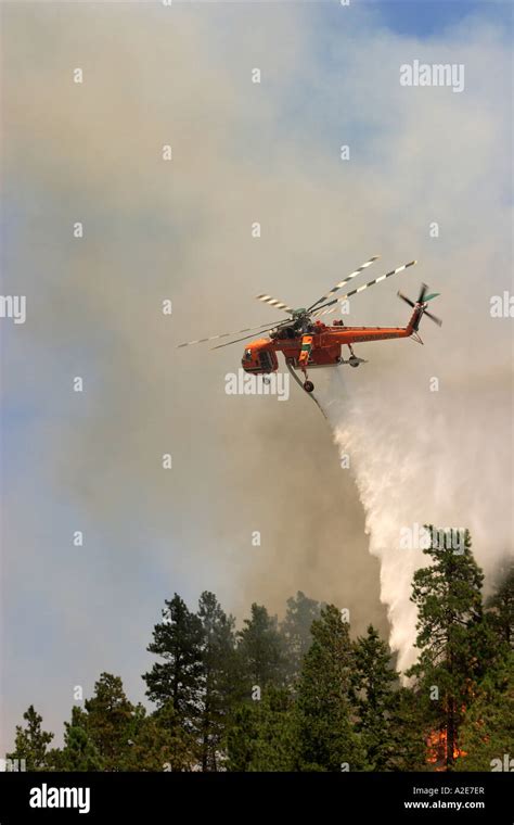 Sikorsky Helicopter Dropping Water On A Forest Fire With Smoke In The