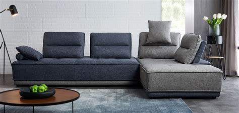 A Living Room With A Couch Chair And Coffee Table In Front Of A Brick Wall