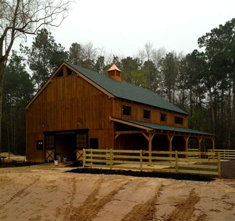 A red barn is an iconic american classic and a common color for horse barns. Horse Barn Framing | Vermont Timber Works