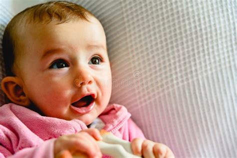Pretty And Adorable 6 Month Old Baby Girl Smiling While Playing With