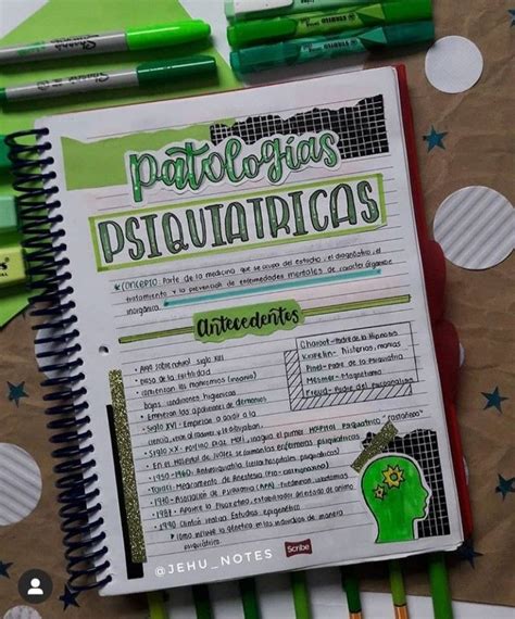 A Notebook With Some Writing On It And Two Green Pens Sitting Next To